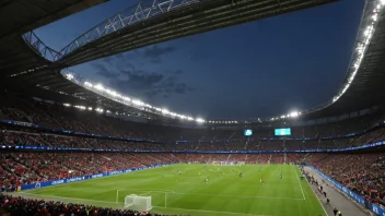 Et fotballstadion med en Mesterligakamp i gang, med tilskuere som heier og spillere som konkurrerer på banen.