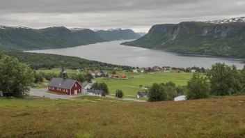 Et pittoreskt norsk landskap med en liten bosetning i det fjerne, med en skilt med navnet 'Tunstads'.