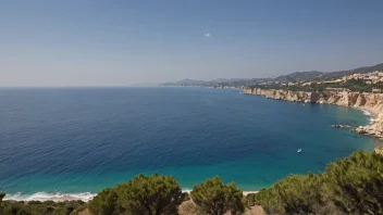 Et vakkert landskap av Middelhavet med en klar blå himmel og noen seilbåter i det fjerne