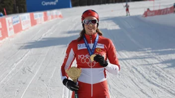 En skiløper på et podium med en gullmedalje