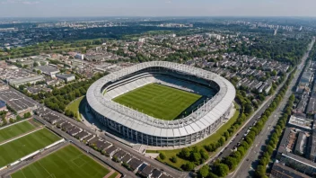 Flyfoto av Monchengladbach by med en fotballstadion i sentrum, omgitt av bygninger og trær