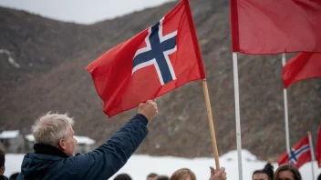 En person som holder et flagg med Arbeiderpartiets logo