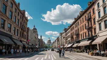 Et bybilde med en blanding av gamle og nye bygninger, en travel gate med mennesker som går og biler som kjører, en klar blå himmel med noen skyer.