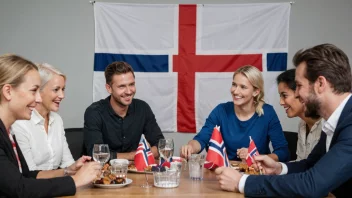 En gruppe mennesker fra ulike kulturer samlet rundt et bord, smiler og chatter, med et norsk flagg i bakgrunnen.