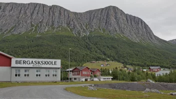 En skolebygning med en skilt som sier 'Bergfagskole' på norsk, med et fjell eller en gruve i bakgrunnen.