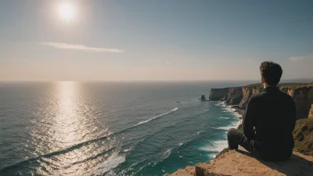 En person som sitter på en klippe og ser ut over havet, og reflekterer over livets mening.